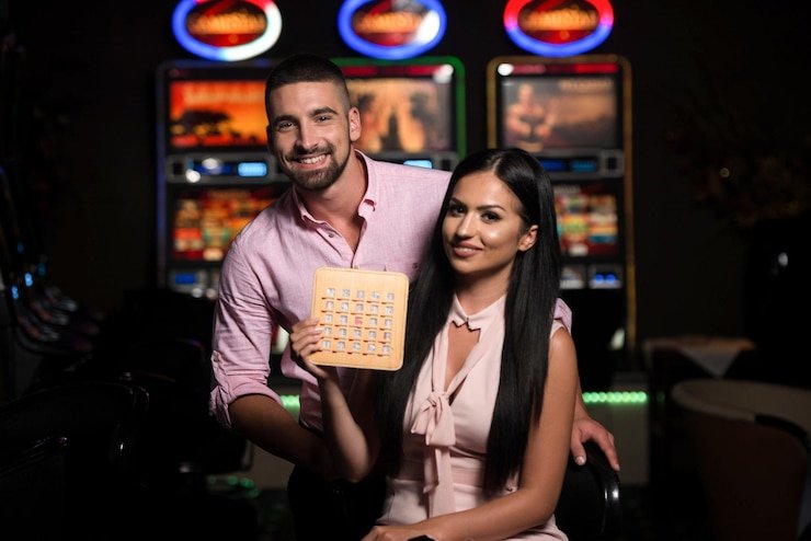 Mobile phone showing live casino dashboard with multiple game options